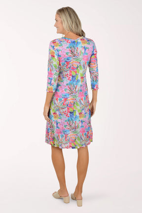 Woman wearing a colorful floral dress on a white background