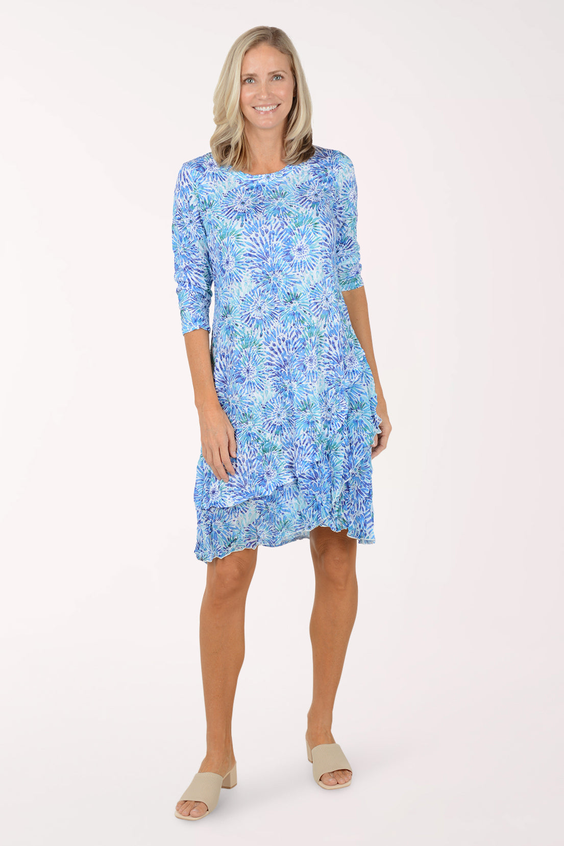 Woman wearing a blue floral dress on a white background