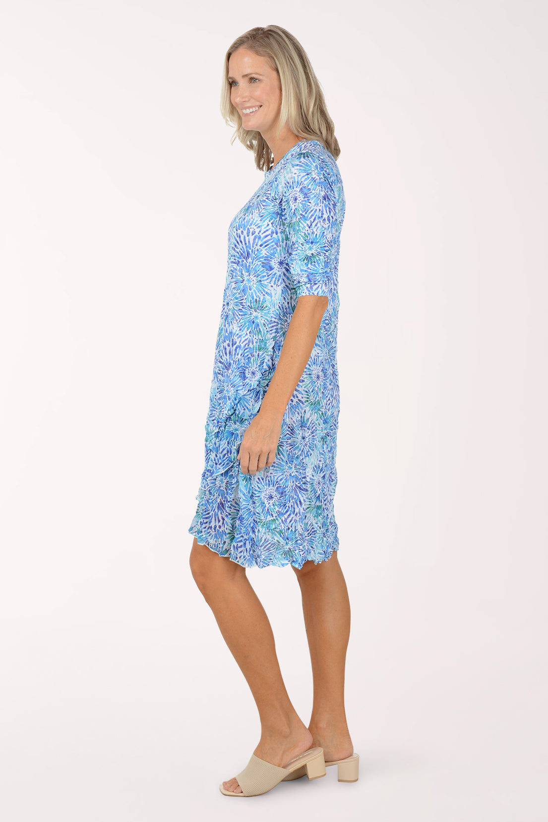 Woman wearing a blue floral dress on a white background