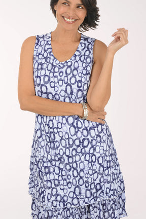 Woman wearing a blue patterned dress on a white background