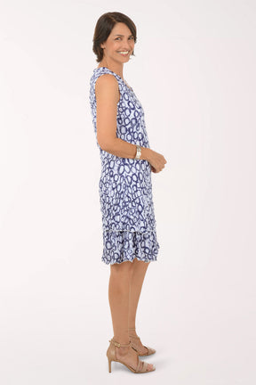 Woman wearing a blue patterned dress on a white background