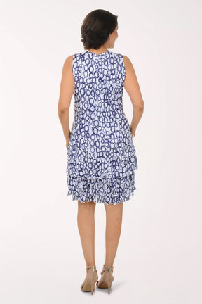Woman wearing a blue patterned dress on a white background