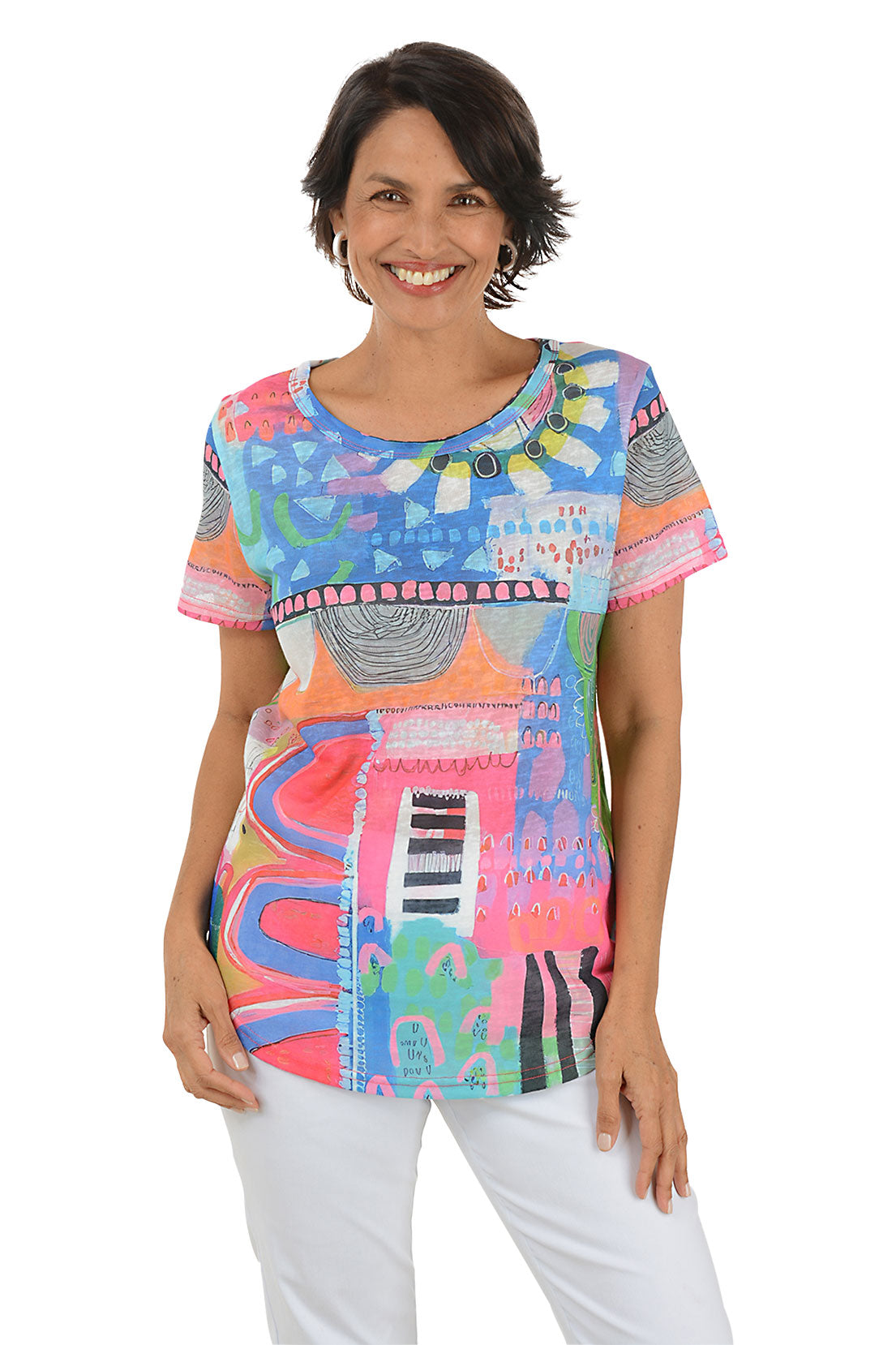 Woman wearing a colorful patterned top on a white background.