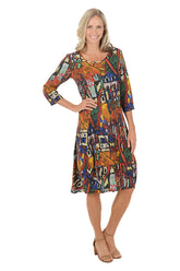 A woman wearing a 3/4 sleeve dress with a multi-colored patterned.