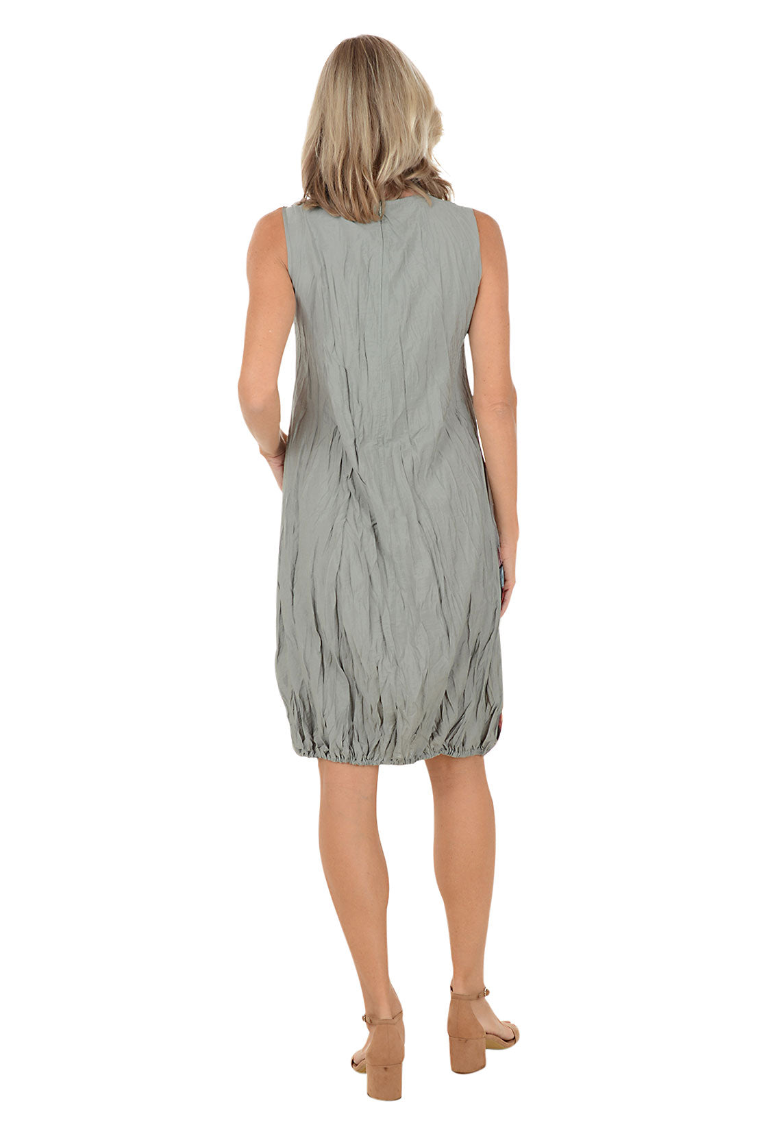 A woman wearing a grey sleeveless dress with a multi color pattered and left hip pocket. Back shot.