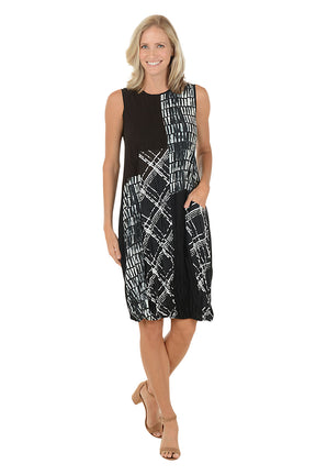 Woman wearing a black and white sleeveless dress with a left hip pocket.