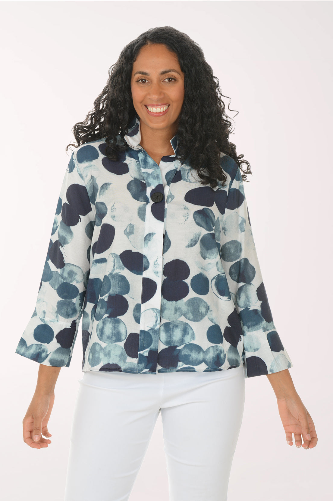Woman wearing a blue and white floral patterned shirt on a white background