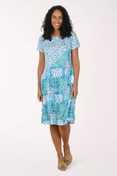Woman wearing a blue patterned dress on a white background