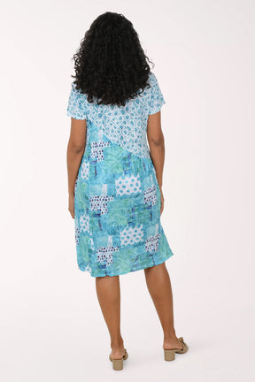 Woman wearing a blue patterned dress on a white background