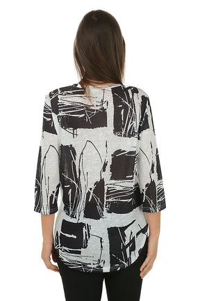 Woman wearing a black and white abstract patterned top on a white background. Back shot.