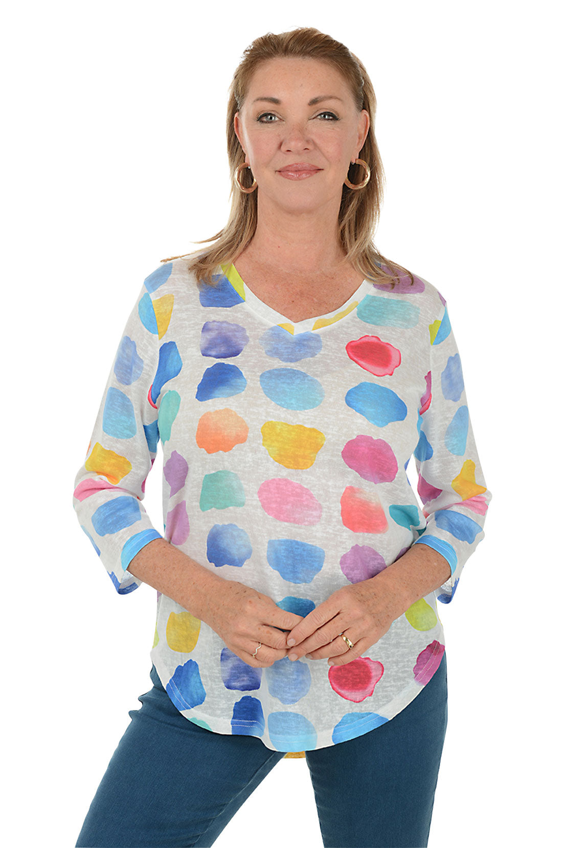 Woman wearing a colorful polka dot shirt on a white background