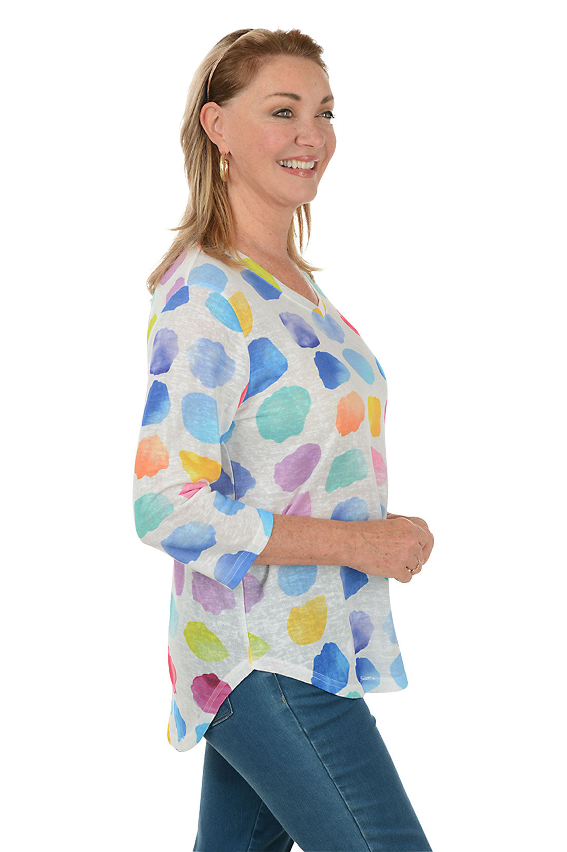 Woman wearing a colorful polka dot shirt on a white background