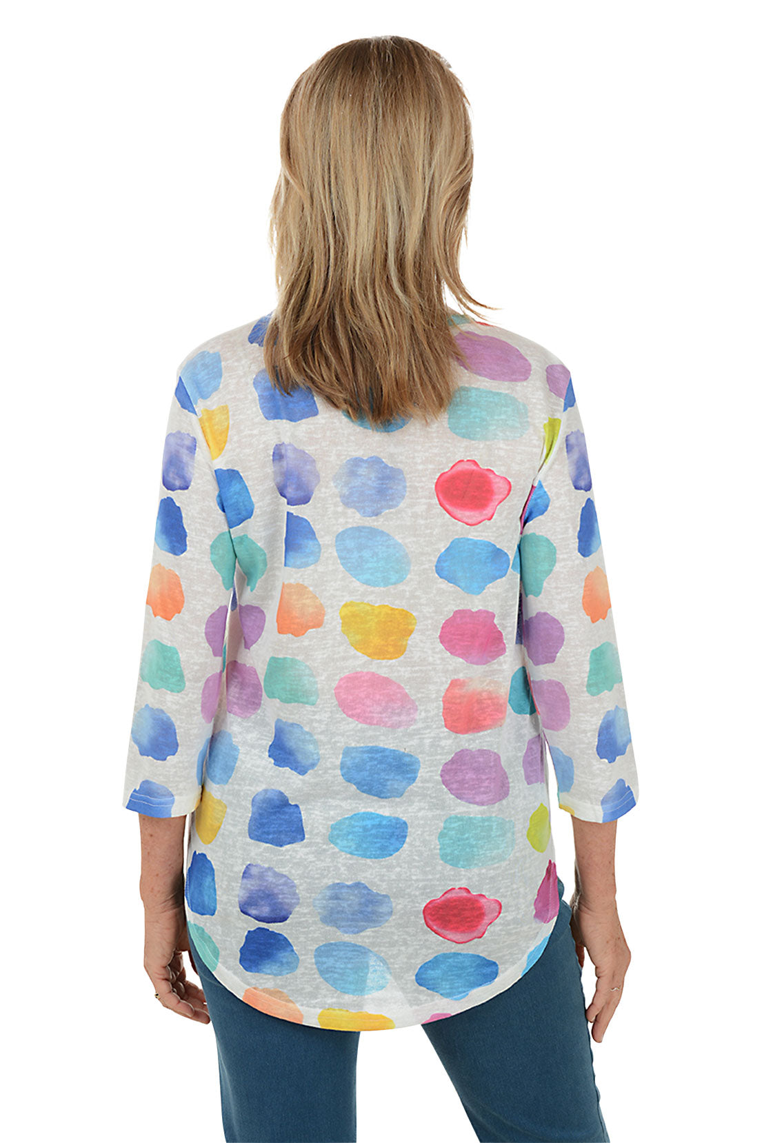 Woman wearing a colorful polka dot shirt on a white background