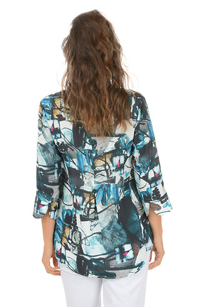 Woman wearing a colorful patterned blouse on a white background. Back shot.