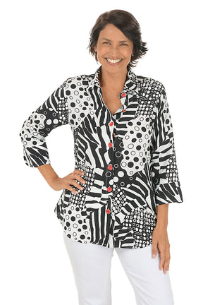 Woman wearing a black and white zebra patterned blouse with red buttons on a white background.