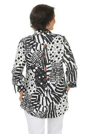 Woman wearing a black and white zebra patterned blouse with red buttons on a white background. Back shot.