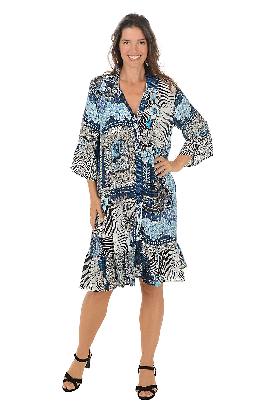 Woman wearing a patterned dress with zebra design on a white background.