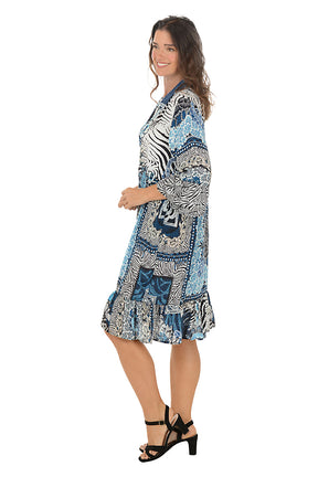 Woman wearing a patterned dress with zebra design on a white background. Side shot.
