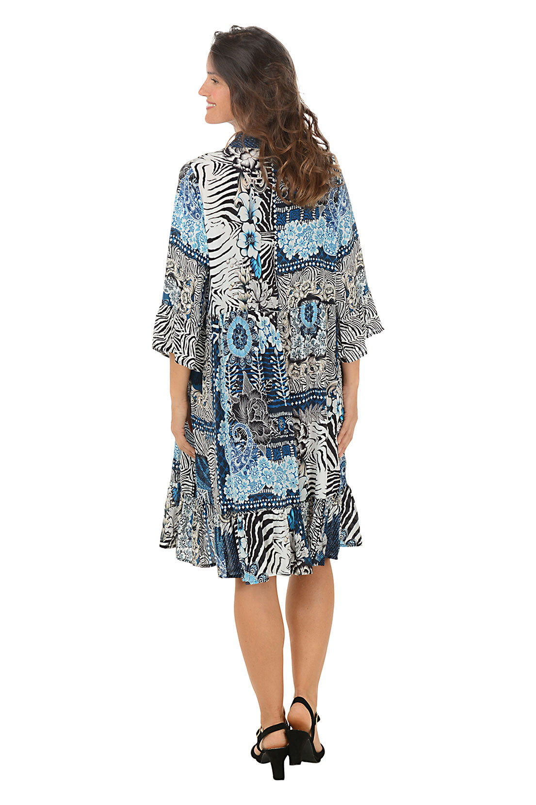 Woman wearing a patterned dress with zebra design on a white background. Back shot.
