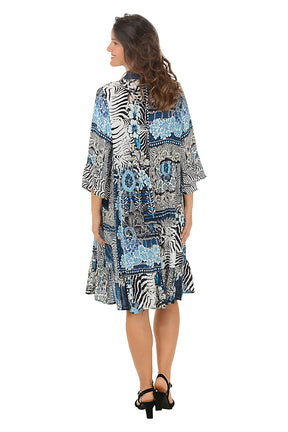 Woman wearing a patterned dress with zebra design on a white background. Back shot.