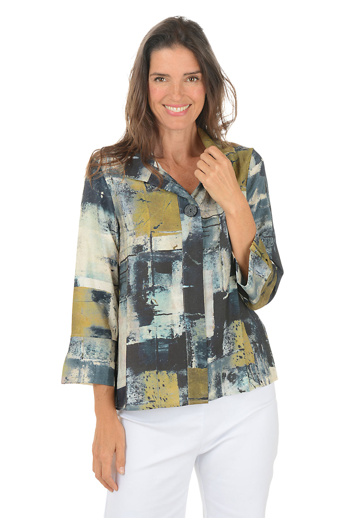 Woman wearing a colorful abstract patterned blouse on a white background.