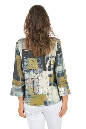 Woman wearing a colorful abstract patterned blouse on a white background. Back shot.
