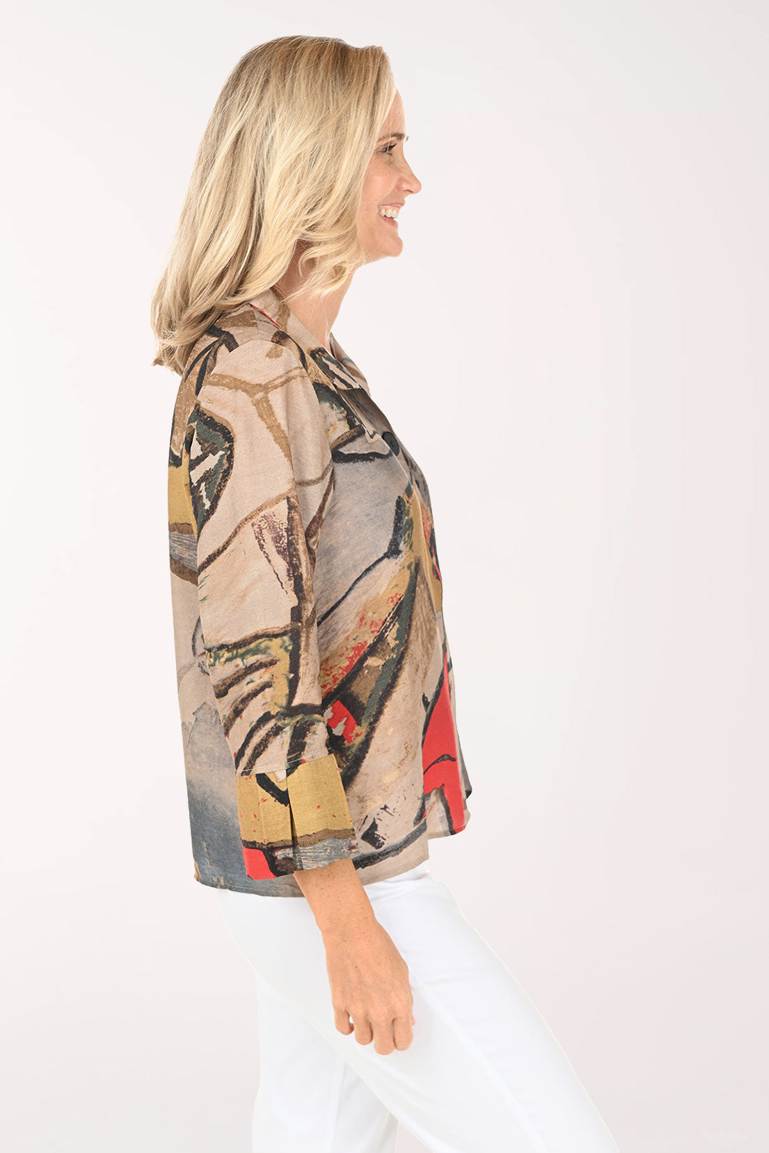 Woman wearing a colorful patterned shirt on a white background