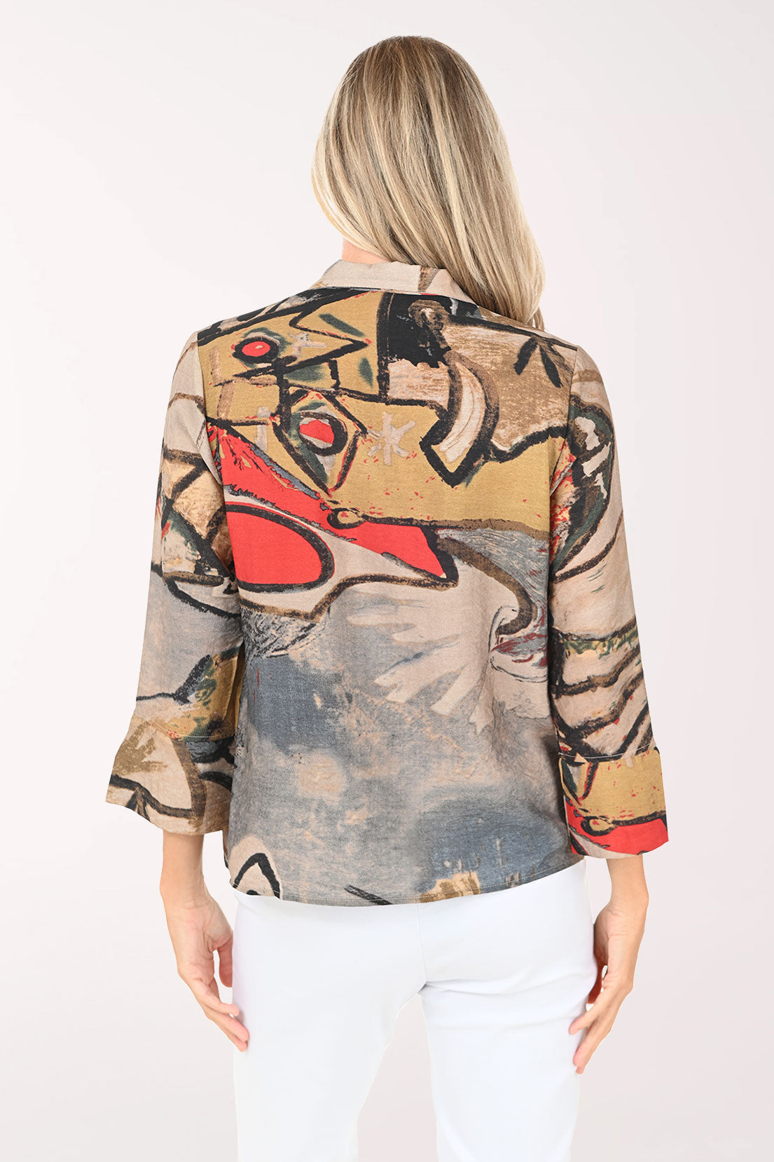 Woman wearing a colorful patterned shirt on a white background