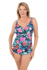 Woman wearing a colorful floral swimsuit on a white background.