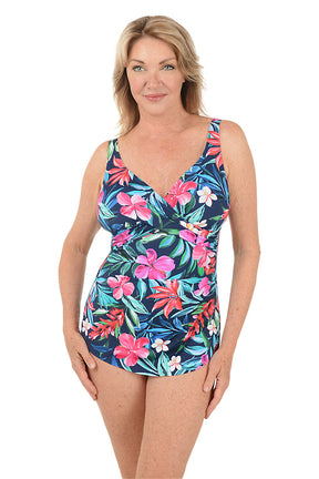 Woman wearing a colorful floral swimsuit on a white background.