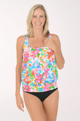 Woman wearing a colorful floral tankini set on a white background.