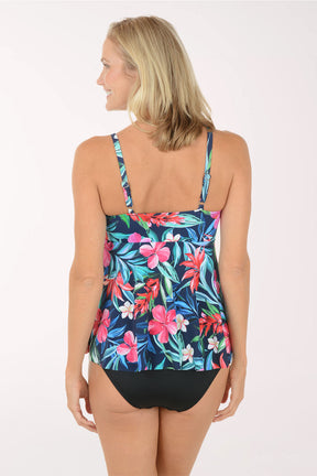 Woman wearing a colorful floral swimsuit on a white background. Back shot.
