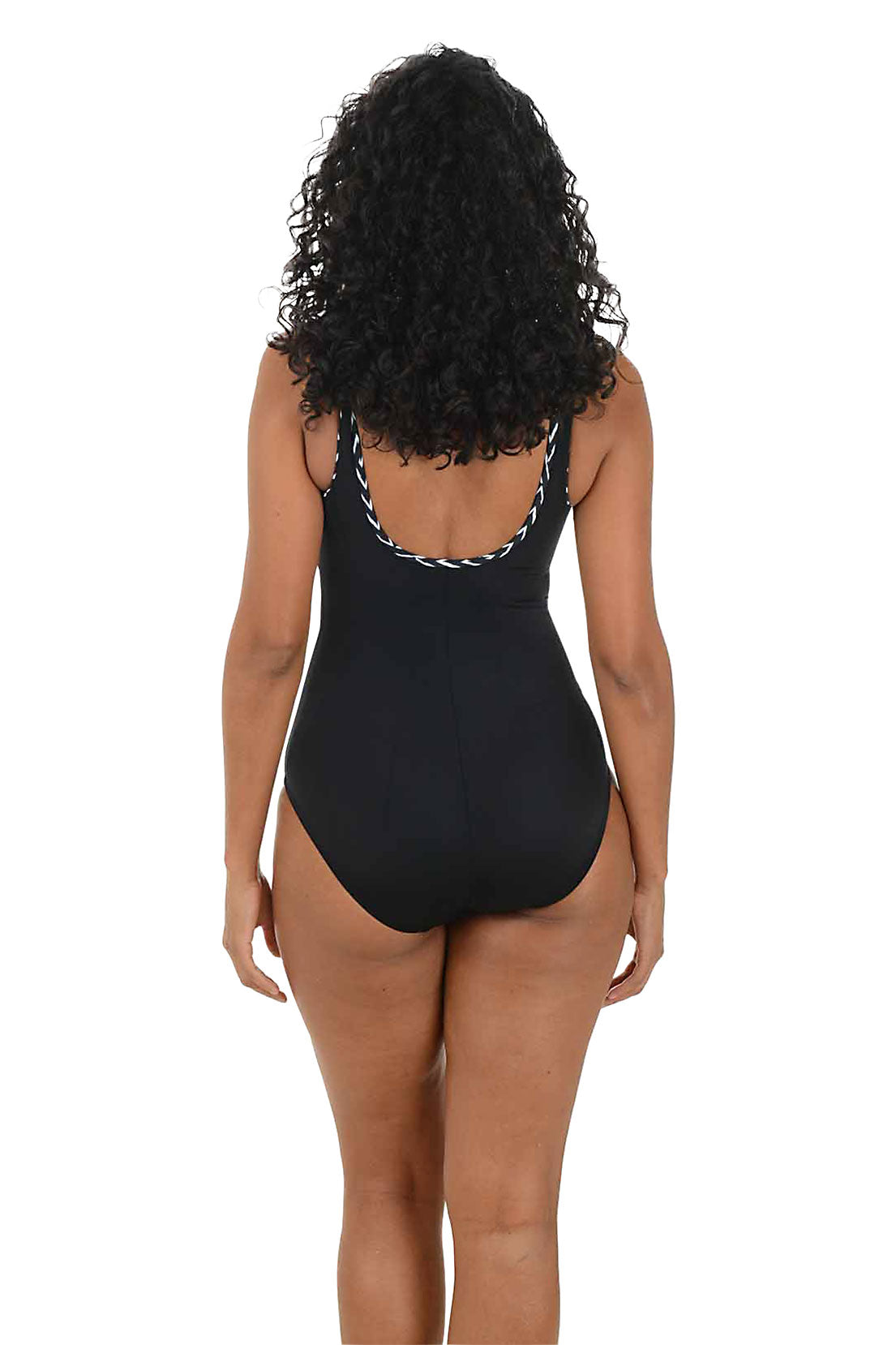 Woman wearing a black swimsuit with black and white decorative straps on a white background. Back shot.