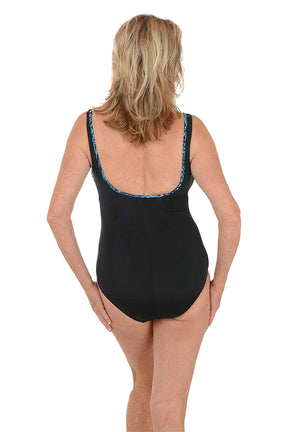 Woman wearing a black swimsuit with a turquoise piping on a white background. Back shot.