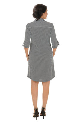 Woman wearing a black and white stripe dress on a white background. Back shot.