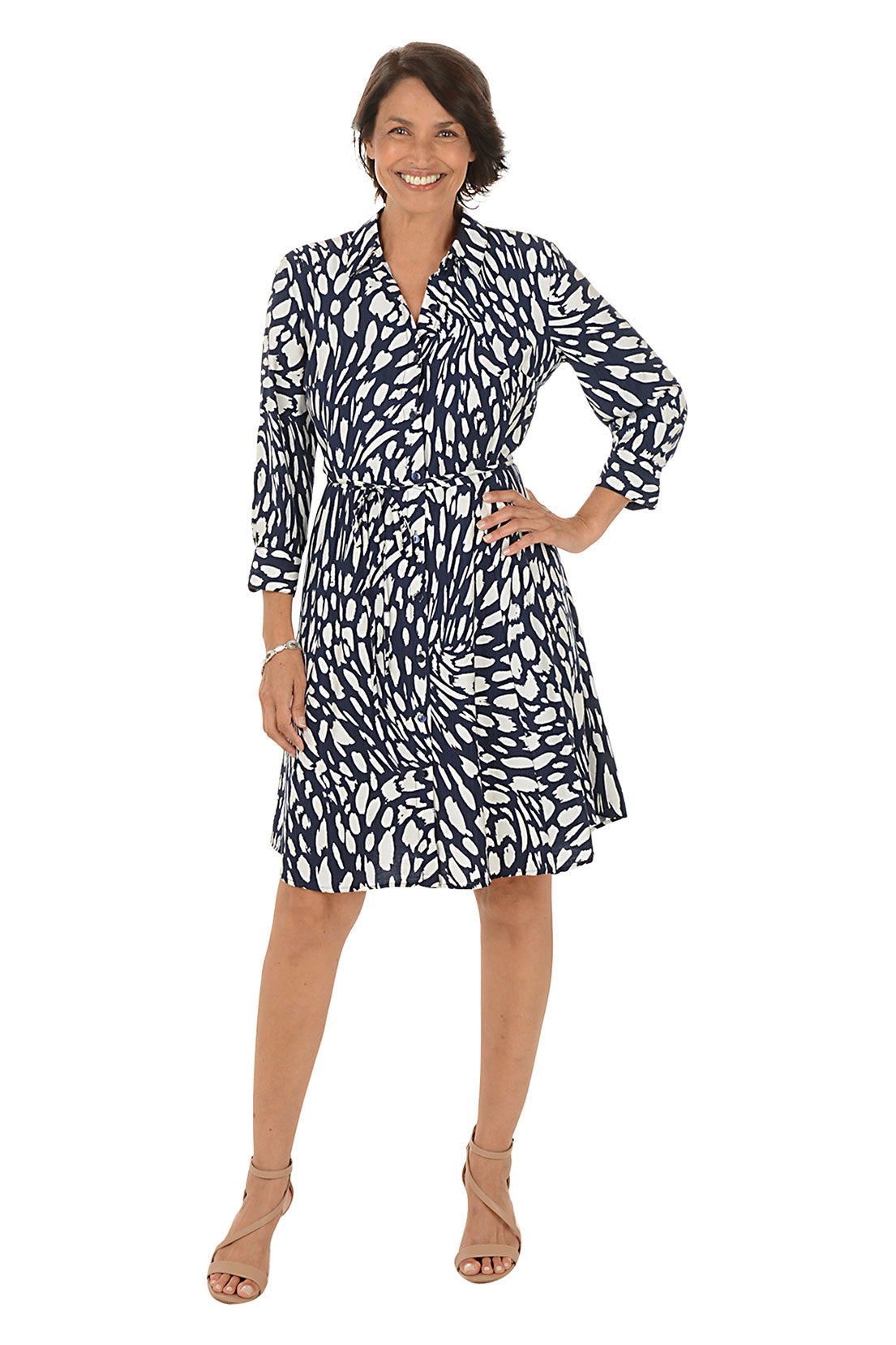 Woman wearing a navy and white patterned dress on a white background.
