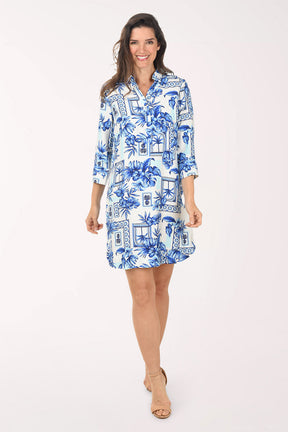 Woman wearing a blue floral dress on a white background