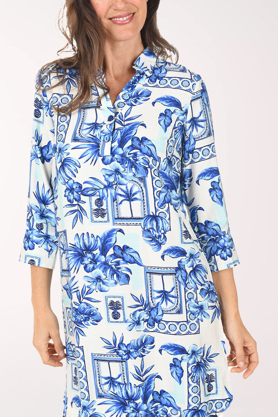 Woman wearing a blue floral dress on a white background