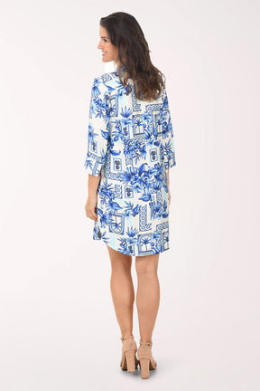 Woman wearing a blue floral dress on a white background