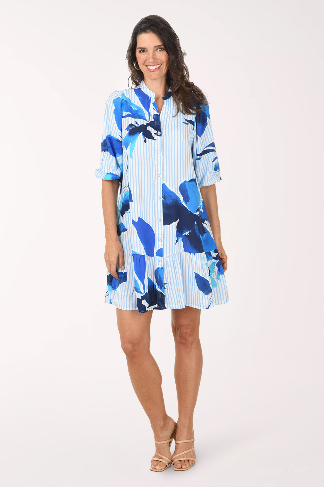 Woman wearing a blue floral dress on a white background