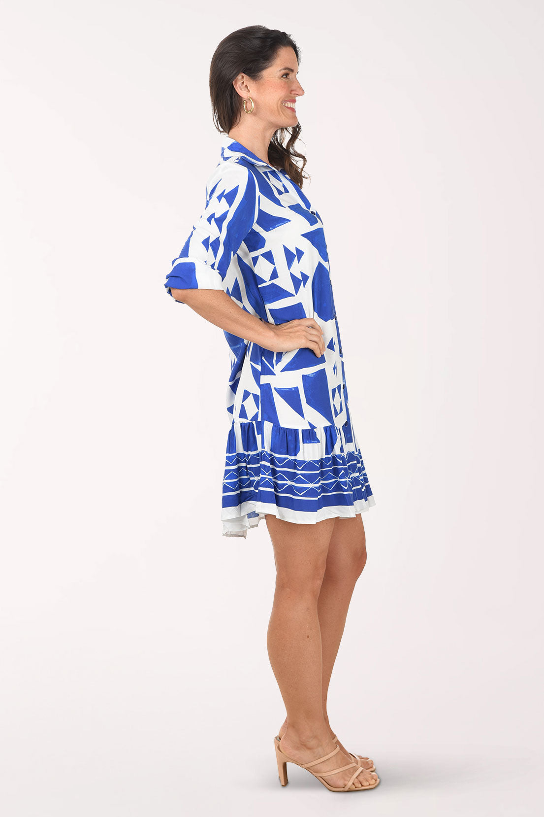 Woman wearing a blue and white patterned dress on a white background