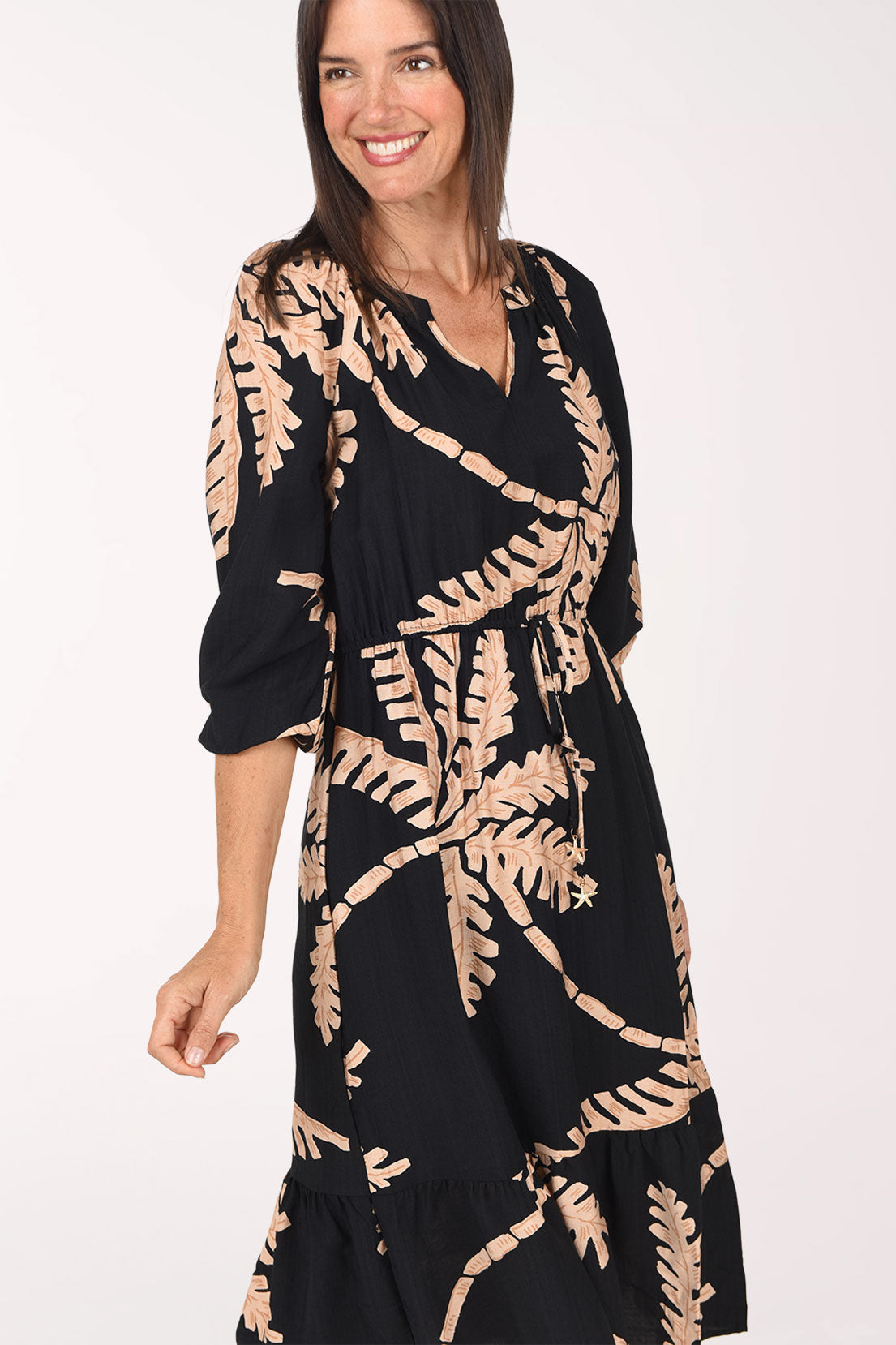 Close-up of the raglan sleeve and palm print on the Coconut Palm Cinched Waist Midi Dress