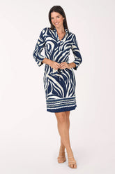 Model wearing the Mlle Gabrielle Blue Swirl Belted Dress, a navy and cream swirl print with a striped hem border, tie belt and 3/4 buttoned sleeves, front view