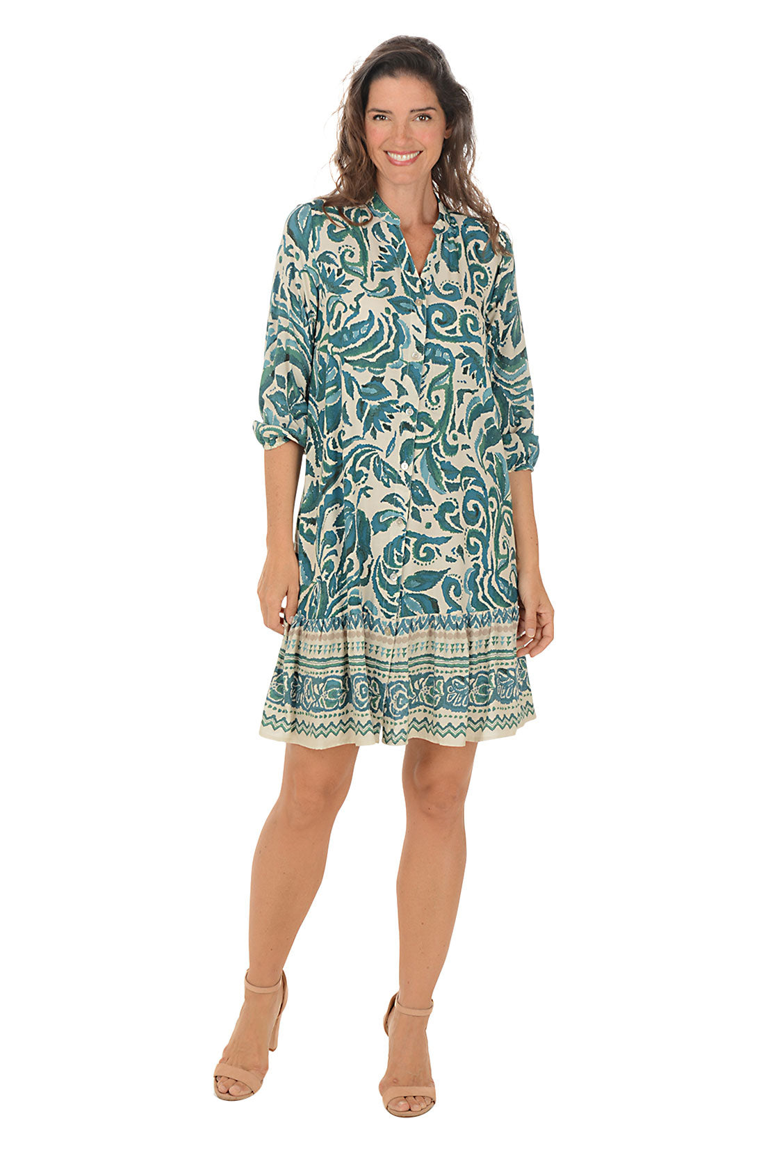 Woman wearing a 3/4 sleeve damask patterned dress in green and white on a white background.