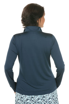 Woman wearing a navy long-sleeve top with a floral skirt on a white background. Back shot.