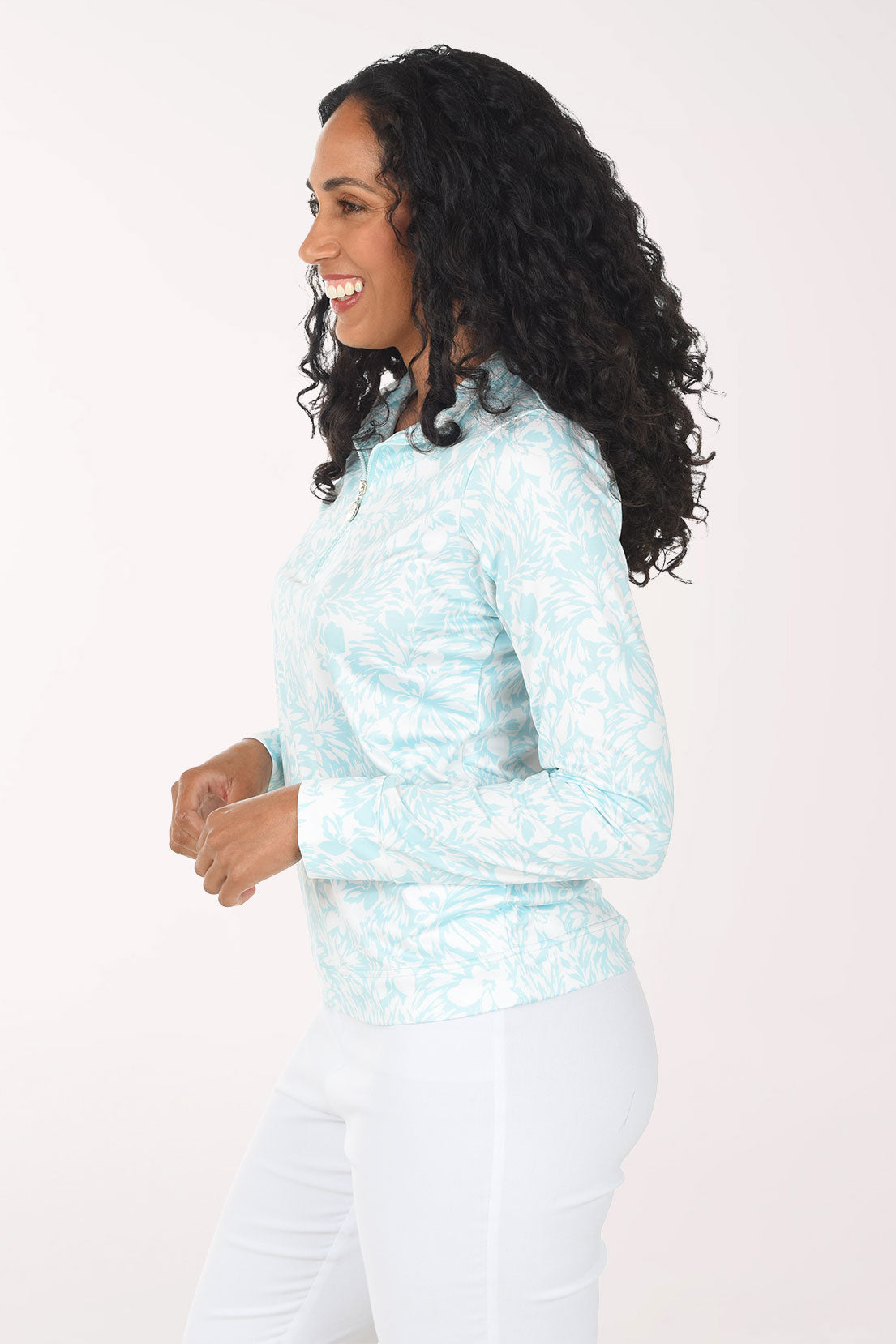 Woman wearing a light blue patterned long-sleeve shirt on a white background