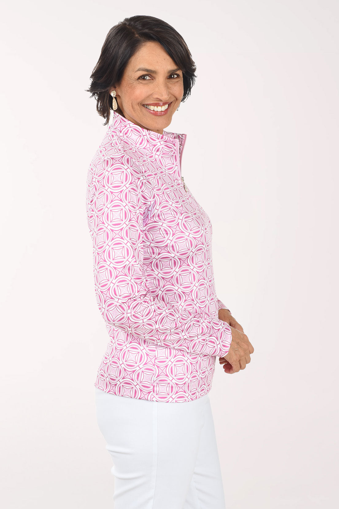 Woman wearing a pink patterned shirt on a white background