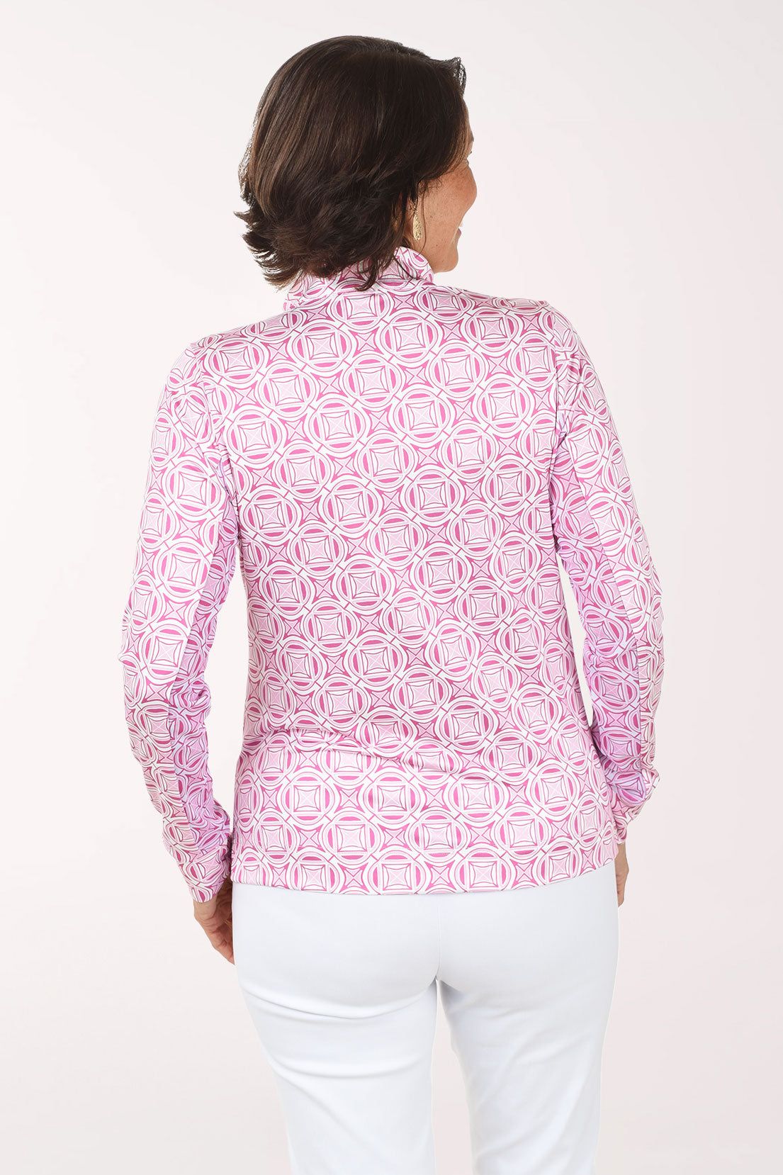 Woman wearing a pink patterned shirt on a white background