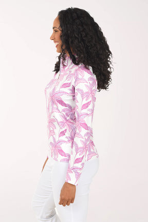 Woman wearing a pink palm leaf patterned jacket on a white background
