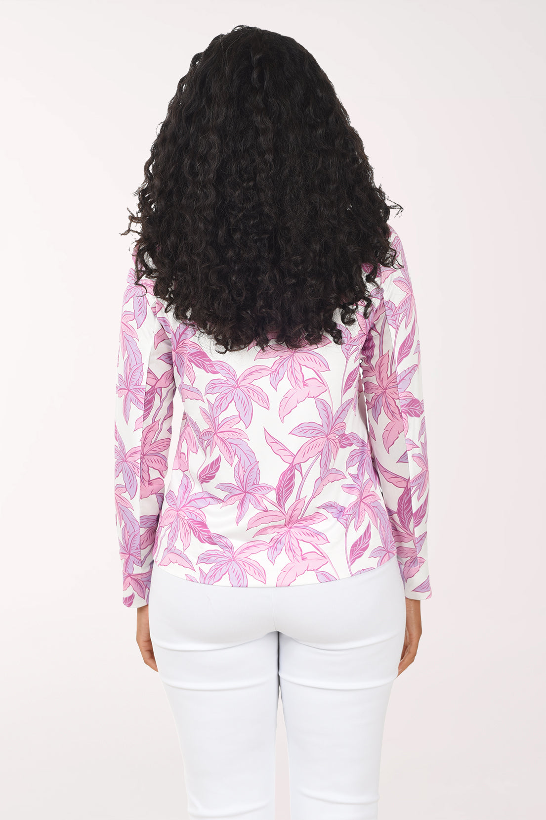 Woman wearing a pink palm leaf patterned jacket on a white background